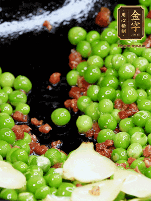 鍋內(nèi)少許油，下火腿煸香，再下甜豆米、百合翻炒，少許鹽、一點水煮到收干